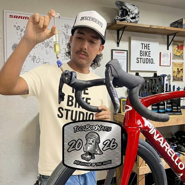 Jason Martinez, Founder and Lead Mechanic at The Bike Studio, performing a hydraulic brake bleed in his Fullerton, CA bike repair workshop
